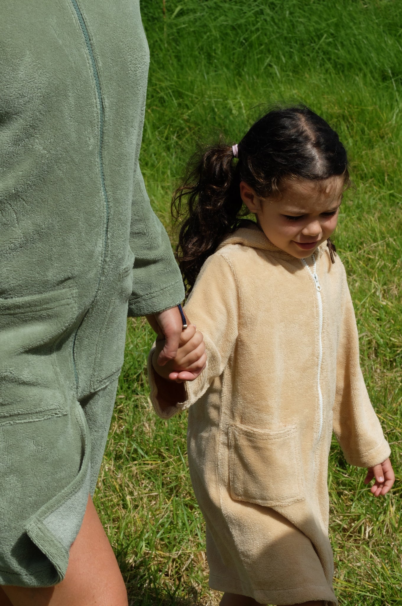 Toddler wearing a Sandcastle hooded towel from Capimiri brand by the river in Portugal.