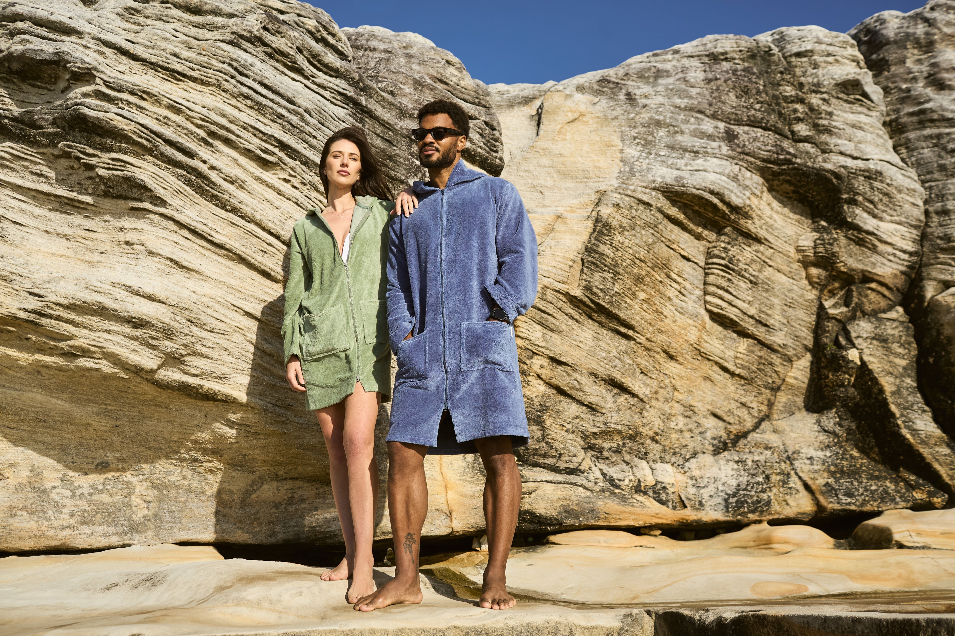 A couple wearing deep blue and cactus hooded towels for CAPIMIRI shooting photo.