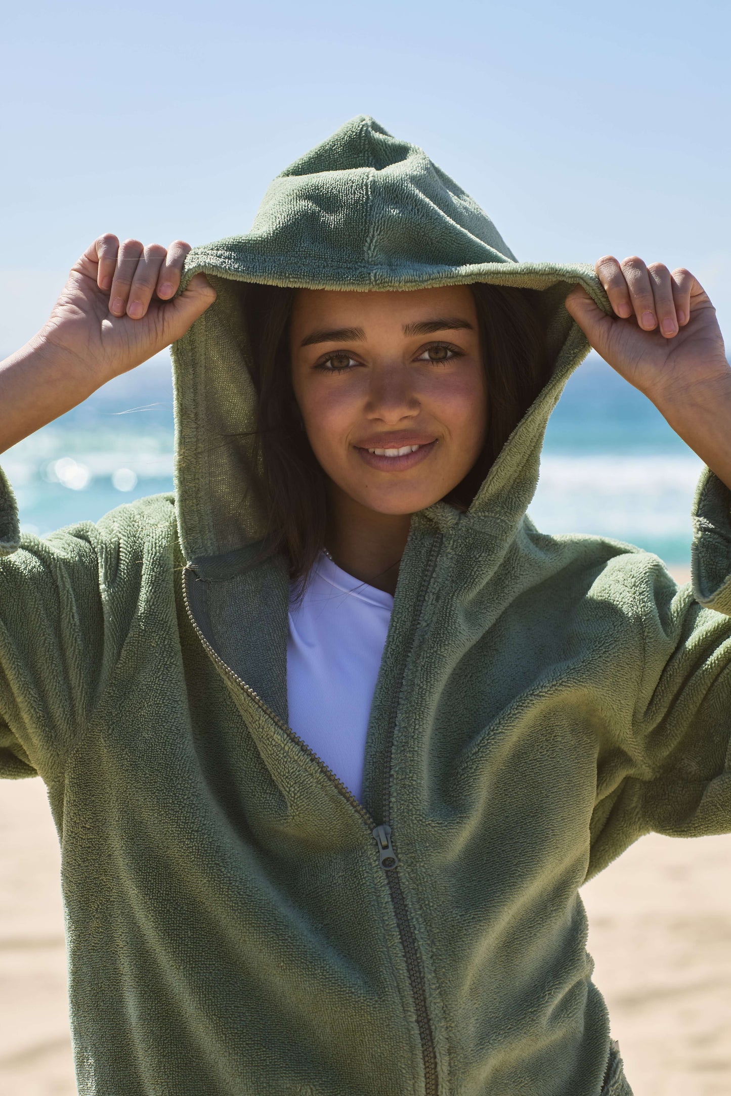 Teenager wearing a cactus poncho by the beach. Cactus Pre Teens & Teens
