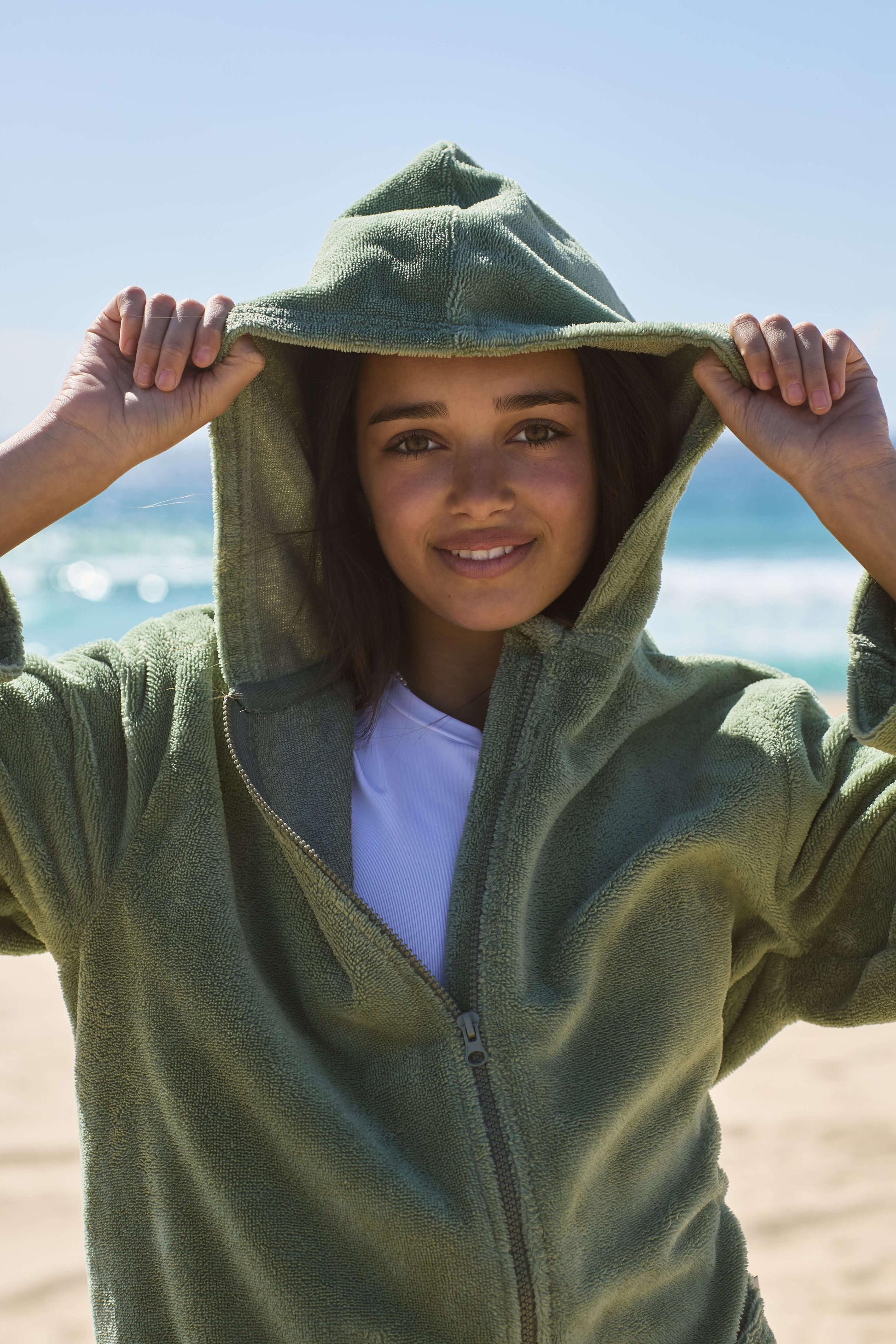 Teenager wearing a cactus poncho by the beach. Cactus Pre Teens & Teens