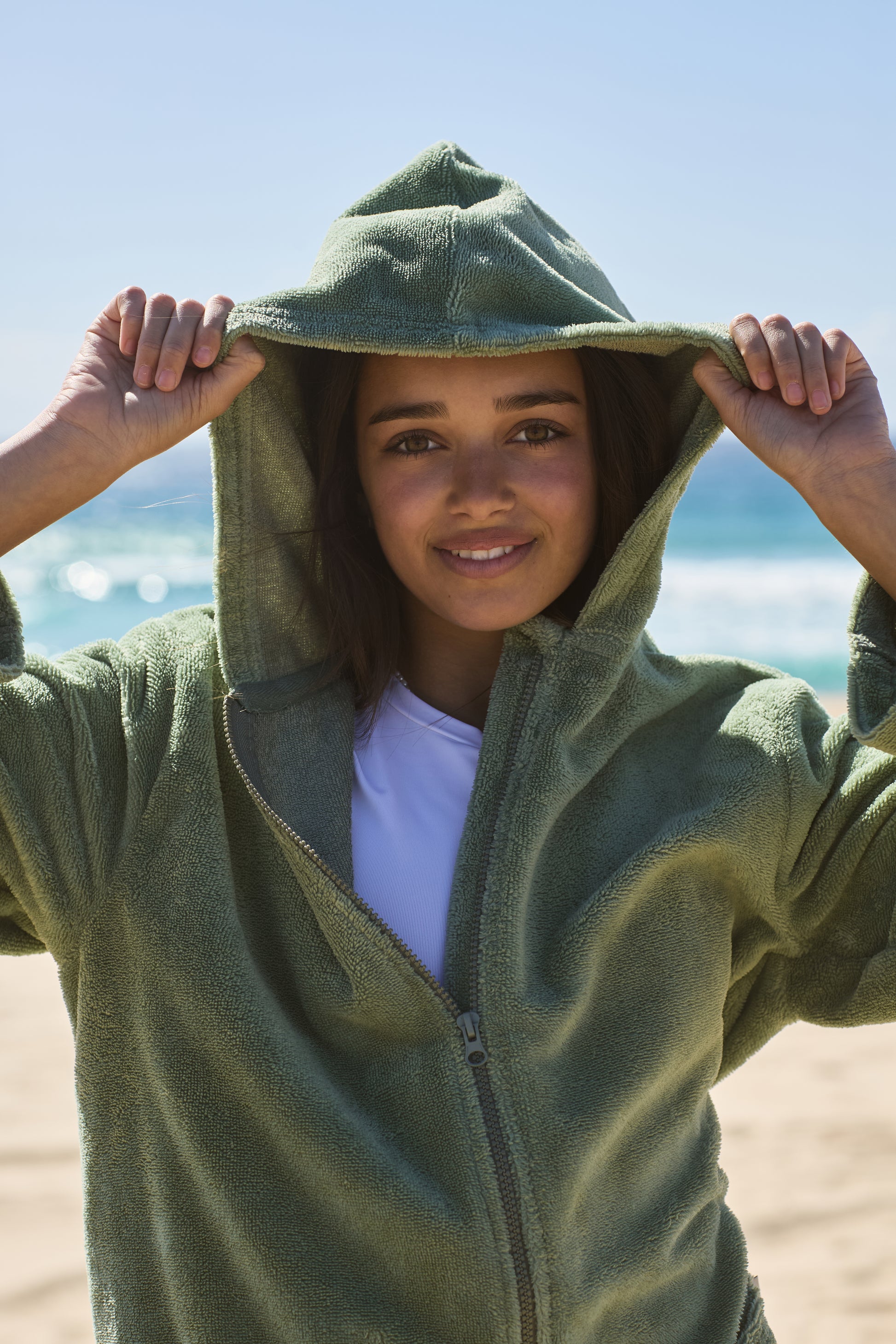 Teenager wearing a cactus poncho by the beach. Cactus Pre Teens & Teens