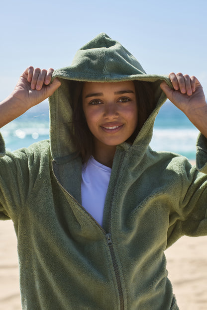 Teenager wearing a cactus poncho by the beach. Cactus Pre Teens & Teens