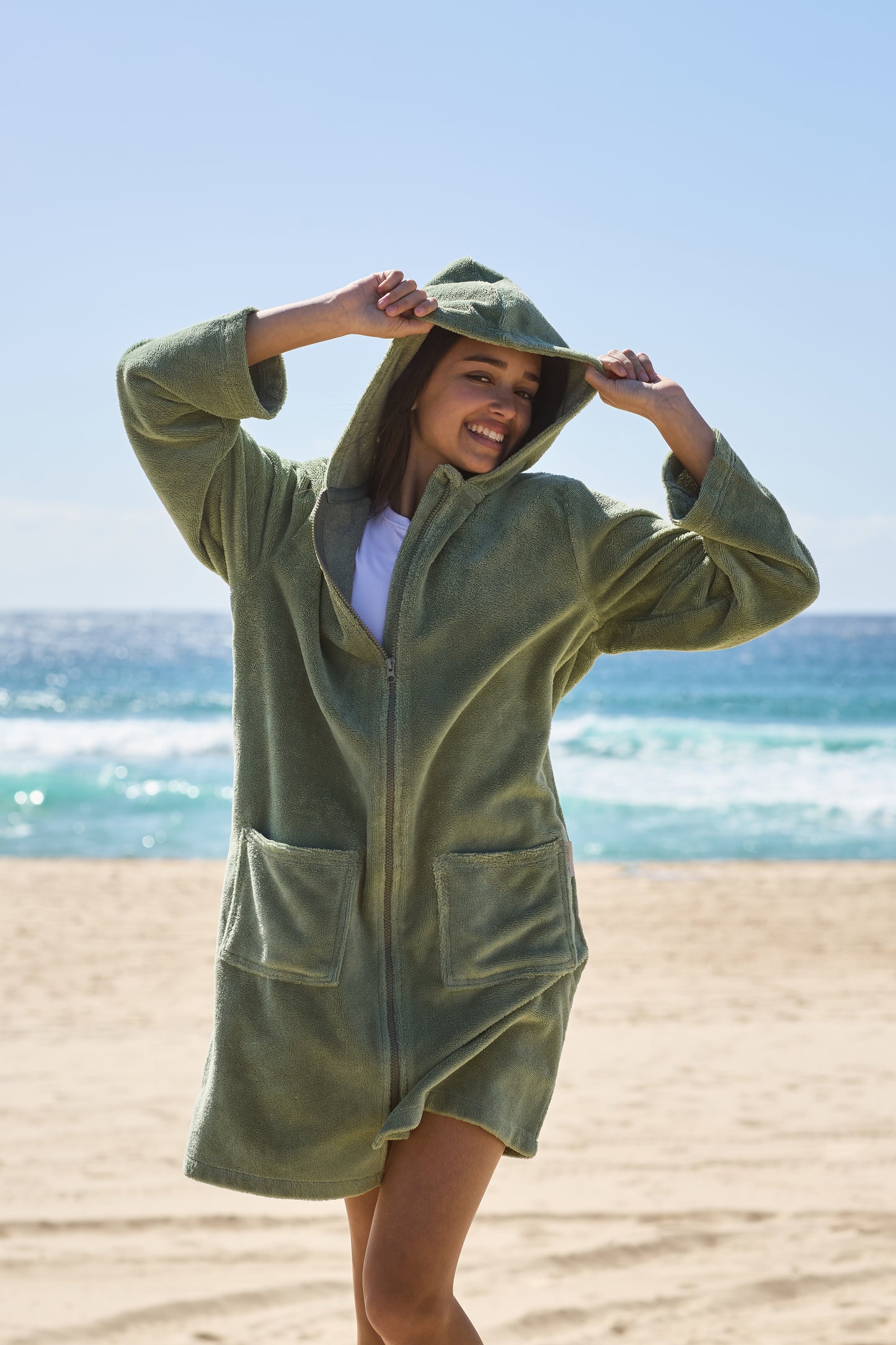 Young lady smiling at life with her green hooded towel on. Cactus Pre Teens & Teens