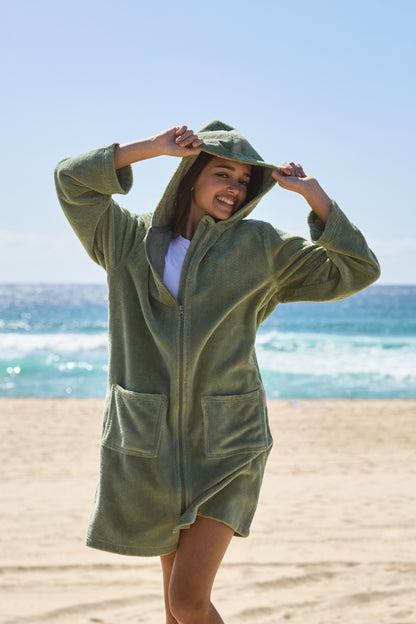 Young lady smiling at life with her green hooded towel on. Cactus Pre Teens & Teens